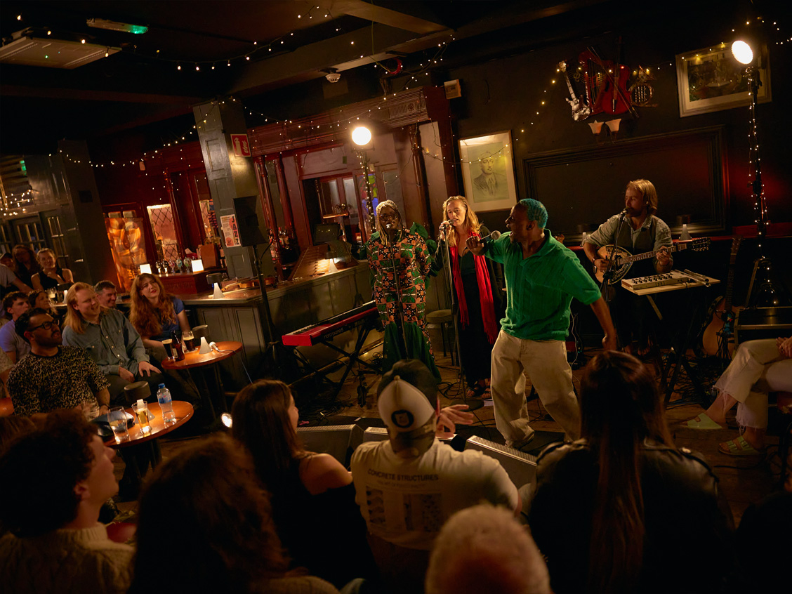 A trad session in a Dublin pub, singers performing for a packed crowd