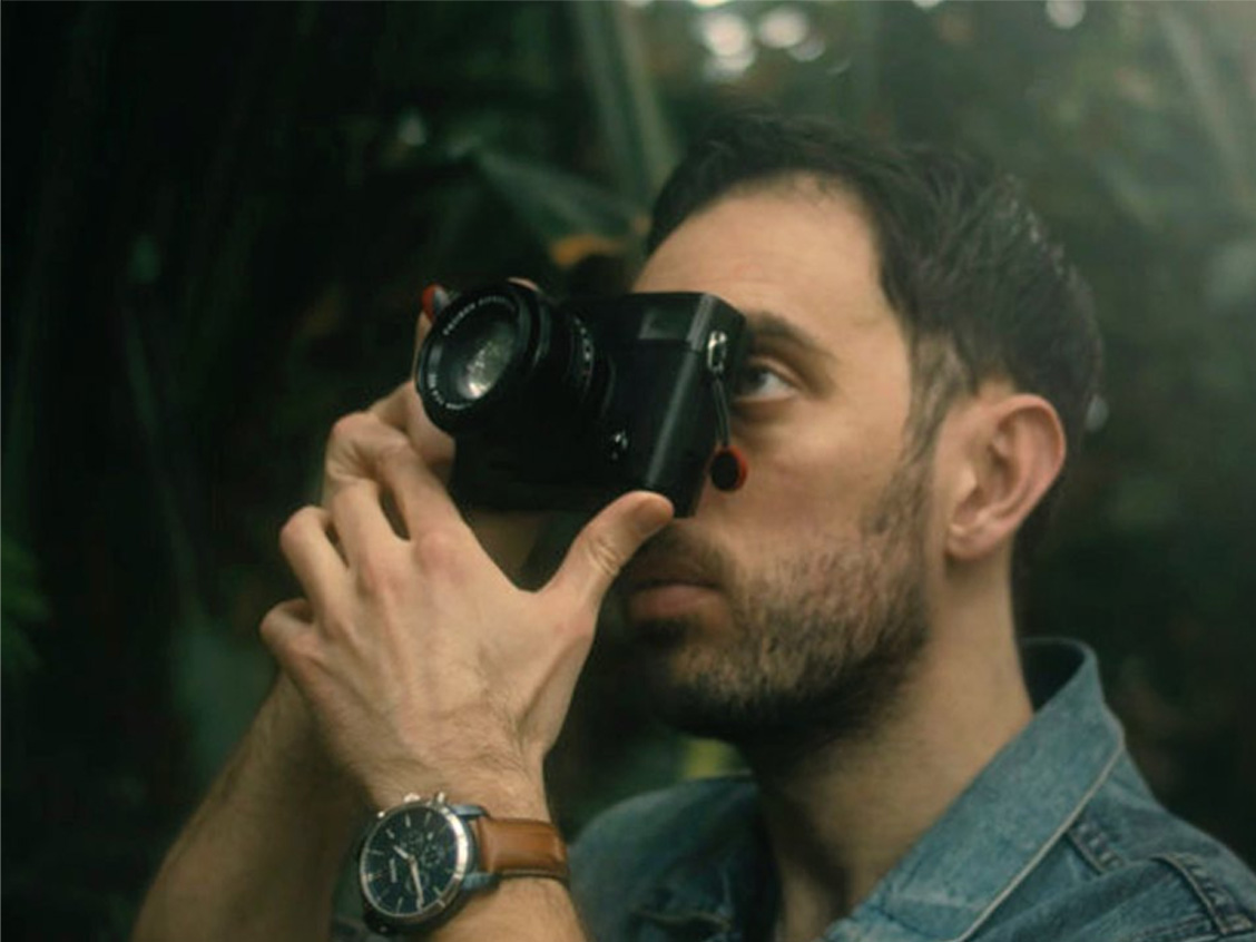 Cathal shooting on a mirrorless camera among greenery